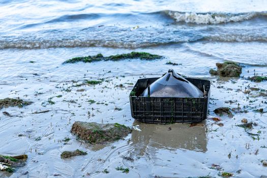 old television set found on the beach. trash left by tourists. Trash thrown on the ocean or beach damaging the environment