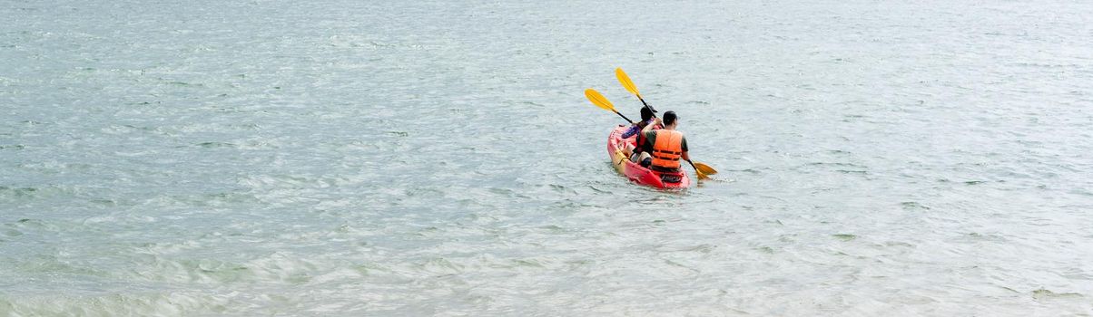 Green blue sea waters with some kayaker men during day. Ocean waters with water sports like kayaking