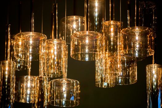 Yellow glass lamps on a dark background.