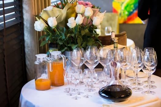 Preparing for the buffet. Restaurant table with glasses and drinks.