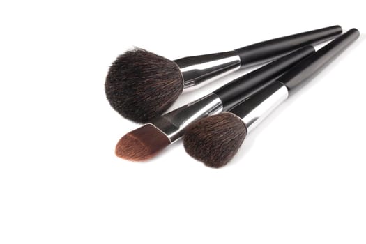 Cosmetic brushes for applying makeup. Makeup artist accessories isolated on white background. Accessories for the perfect make-up of the skin of the face.
