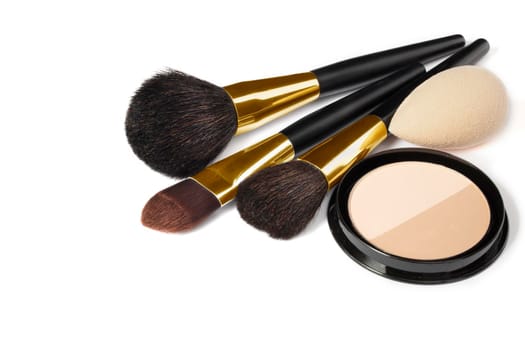 Loose powder, various makeup brushes. Makeup artist accessories isolated on white background. Products for perfect facial skin makeup.