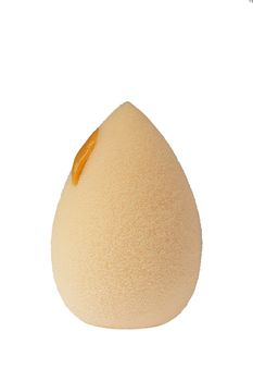 Cosmetic face sponge with a drop of foundation cream isolated on a white background.