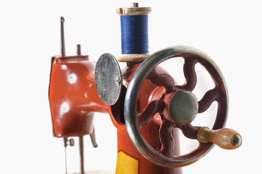 Fragment of a retro sewing machine with bobbin. Children's Soviet sewing machine toy.