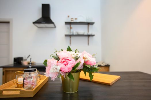 Kitchen table with flowers and a tray. Beautiful kitchen interior.