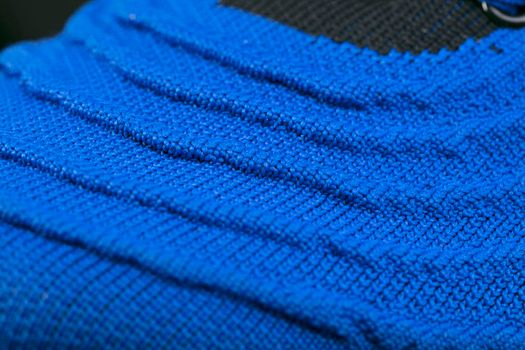 Part of a blue sneaker made of fabric. A fragment of sports shoes.
