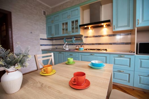 Kitchen in a small apartment. Table with cups on a background of the kitchen.