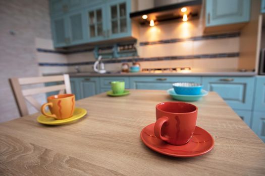 Tea cups on the table against the background of the kitchen.