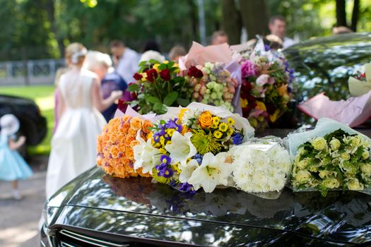 Flowers on a wedding car. Wedding day.