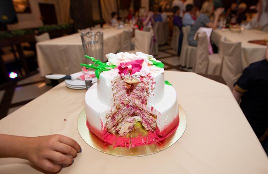 Beautiful cut cake on a restaurant background.