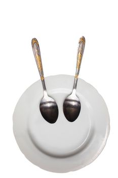 Plate with spoons on a white background. Funny dishes. Plate with a smile.