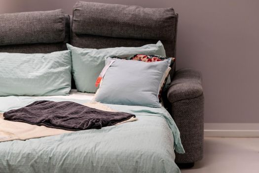 Sofa bed with colorful pillows on sale from a store