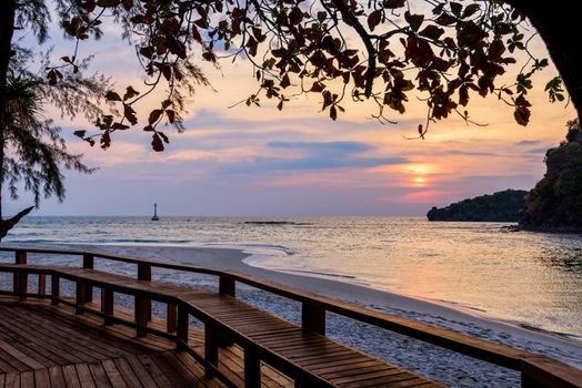 Beautiful nature landscape of colorful the sun on the sky at Tarutao island beach during the sunset over the Andaman Sea under the tree shadow, Tarutao National Park, Satun, Thailand