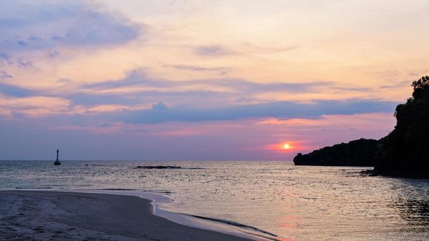 Beautiful nature landscape of colorful the sun on the sky at Tarutao island beach during the sunset over the Andaman Sea, Tarutao National Park, Satun, Thailand, 16:9 wide screen