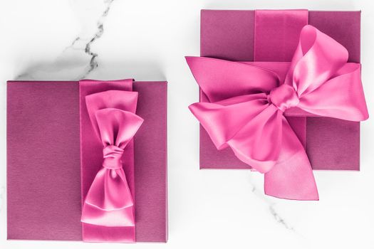 Birthday, wedding and girly branding concept - Pink gift box with silk bow on marble background, girl baby shower present and glamour fashion gift for luxury beauty brand, holiday flatlay art design