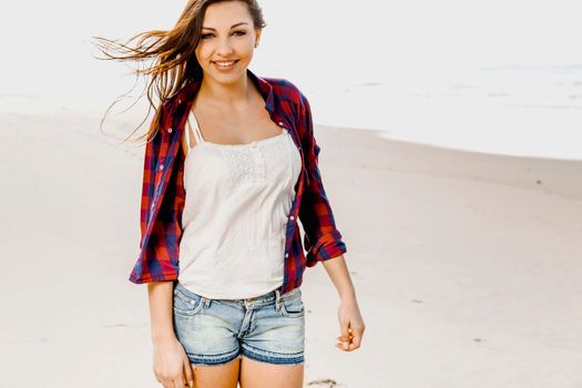 Portrtait of a happy girl at the beach enjoying the life