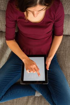 Gorgeous woman using a digital tablet indoors, with copy space 