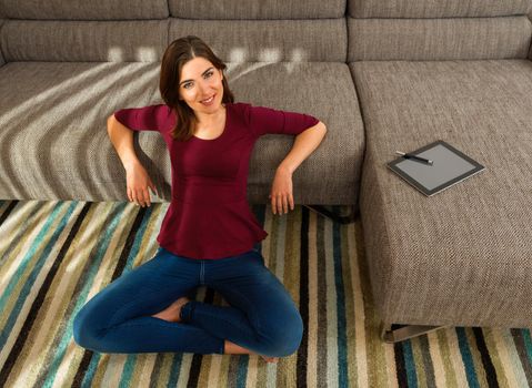 Gorgeous woman at home working with a tablet