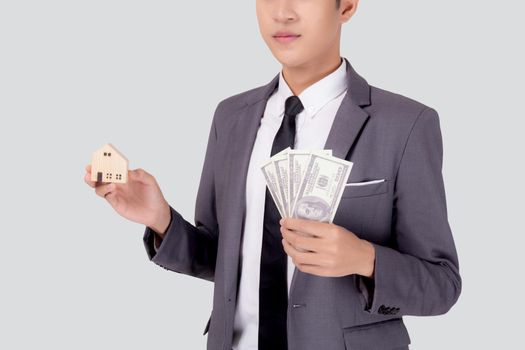 Young asian business man holding home and money dollar for saving for future, insurance agent and credit, debt and loan of finance, purchase home and refinance, investment about real property.