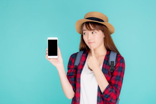 Beautiful young asian woman showing smart mobile phone for presenting something in travel summer trip in vacation isolated on blue background, asia girl holding smartphone and thinking idea.