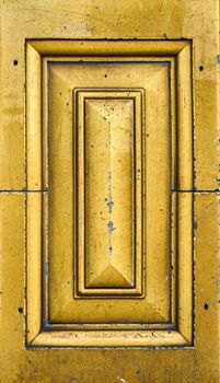 A close up look at the detail of some warm yellow and gold victorian tiling that shows some age and weathering.