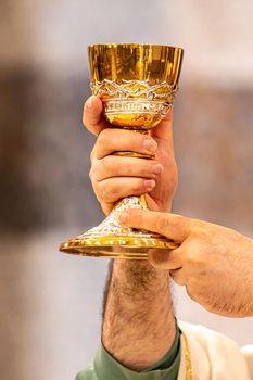 chalice of wine during the eucharistic rite of the holy mass in the church