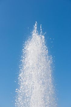 closeup water splash against blue sky, freeze motion photography