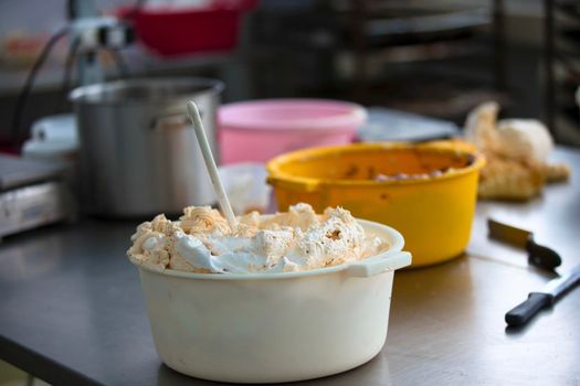 A lot of cream for cakes in the industrial kitchen. Cream for culinary products