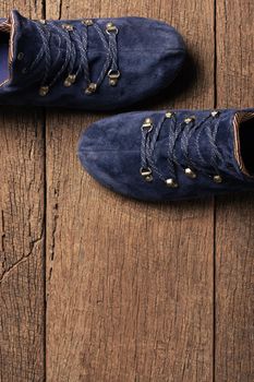 blue suede shoes isolated on wooden plank