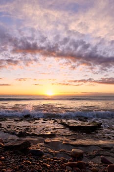 Sunrise on the rocky beach, long exposure, water silk effect
