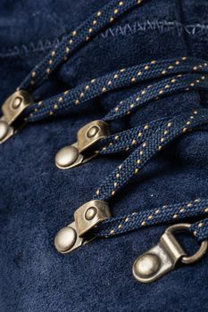 closeup detail of blue suede shoes and shoelace