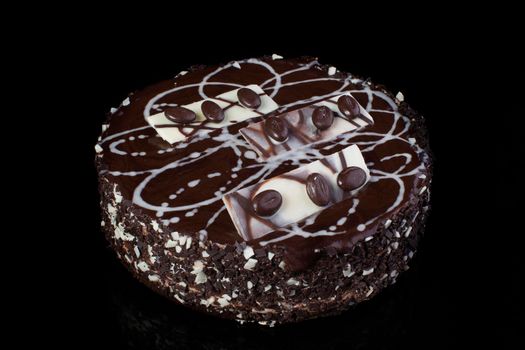 Chocolate cake with coffee beans on a black background