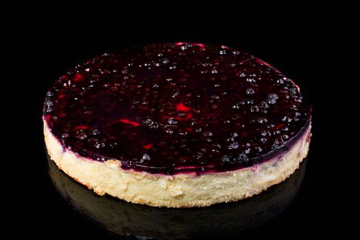 Cake cheesecake with cherry in jelly on black background