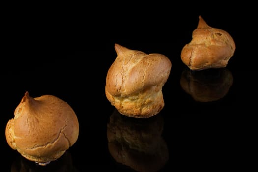 Cake profitroles close-up on a dark background