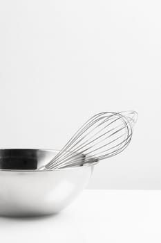 isolated stainless Whisk and stainless bowl on white background