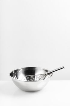 isolated stainless Whisk and stainless bowl on white background