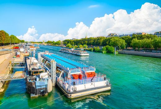 Touristic boats on river Seine in Paris at sunny sunset