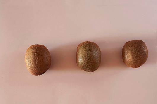 Three kiwis on a white background, symmetry, clean background, shadows