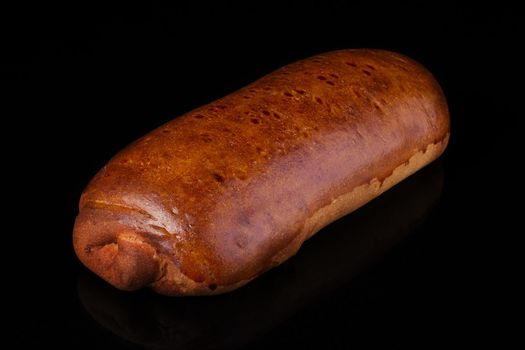 Loaf.Traditional bun with yeast dough on a dark background