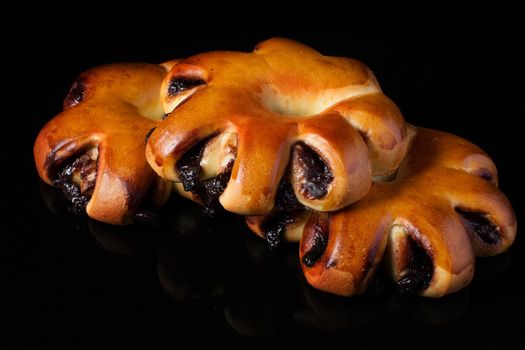 Bun with fruit filling on a dark background