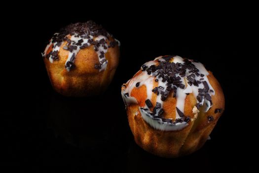 Cupcake muffin with chocolate sprinkle on a dark background