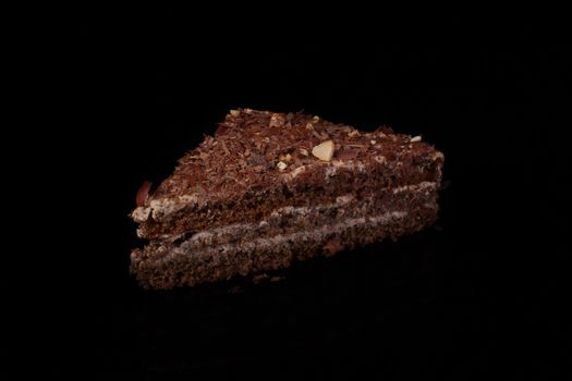 Triangular cake with chocolate sprinkle on a dark background