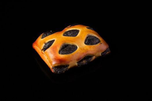 Bun with poppy filling on a dark background