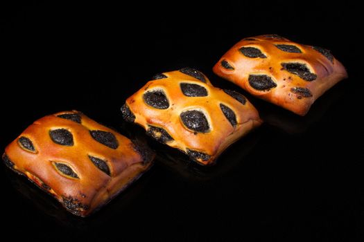 Bun with poppy filling on a dark background