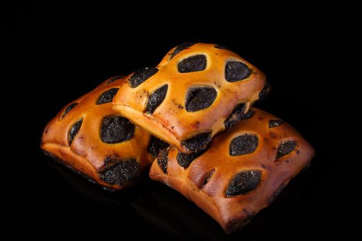 Bun with poppy filling on a dark background