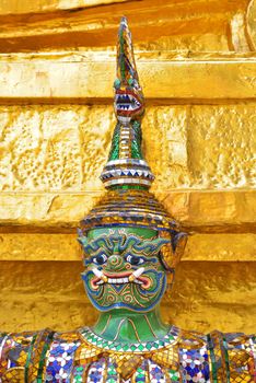 closeup face and headdress of Yak(giant) statue at Wat Phra Kaew in Bangkok, Thailand.