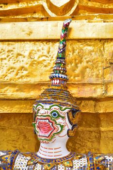 closeup face and headdress of Yak(giant) statue at Wat Phra Kaew in Bangkok, Thailand.