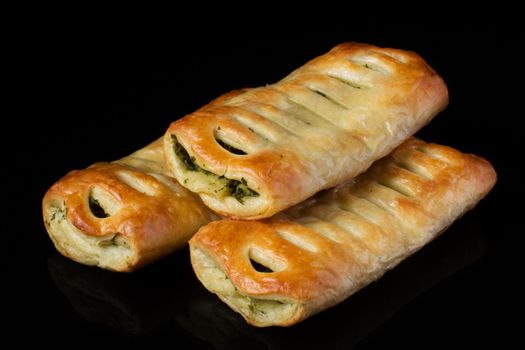 Puff pastry with filling on a black background