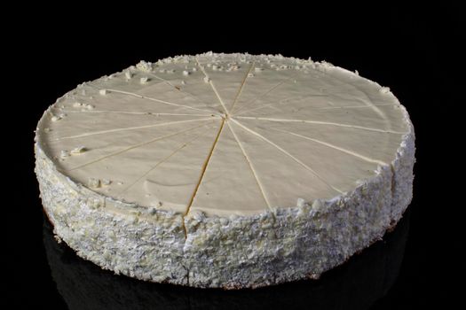 Cake cheesecake sliced in portions on a black background