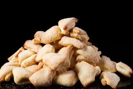 Cookies puff pastry ears on a dark background